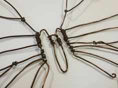 several pieces of wire are arranged in the shape of a butterfly