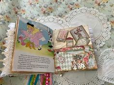 an open book sitting on top of a doily