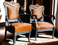 two chairs sitting next to each other on top of a rug