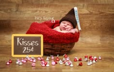 a baby is sleeping in a basket with kisses on the floor next to candy candies