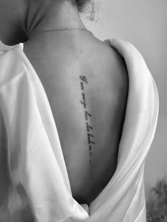 the back of a woman's neck with writing on it