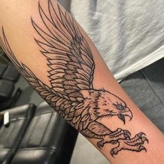 an eagle tattoo is shown on the arm