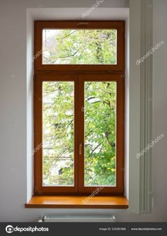 an open window in a white room with wood trimming and wooden windowsills