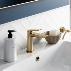 a bathroom sink with soap dispenser next to it