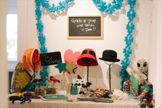 a table topped with lots of hats and decorations