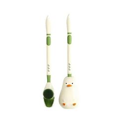 two green and white toothbrushes sitting next to each other