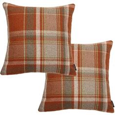 two orange plaid pillows sitting next to each other