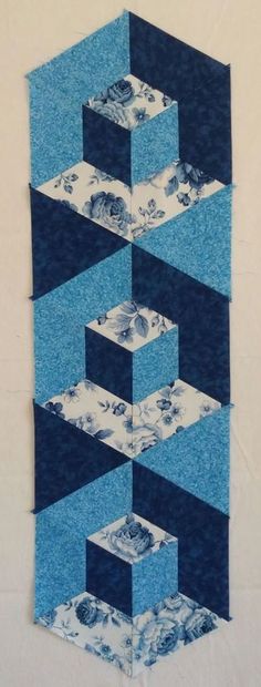 a blue and white piece of fabric with an abstract design on the bottom half of it