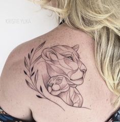 a woman with a lion tattoo on her shoulder and behind her is a floral wreath