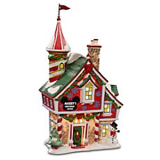 a christmas house with lights and decorations on the roof is shown in front of a white background