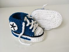 a crocheted blue and white sneaker with a hat on the top is sitting on a table