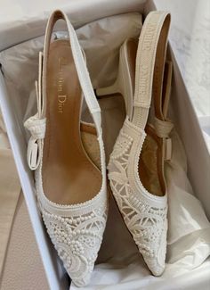 a pair of white shoes in a box