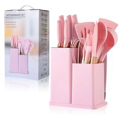 pink utensils are in a holder next to a box