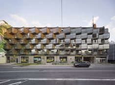 an apartment building with balconies on the roof