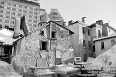 black and white photograph of an old building in the snow