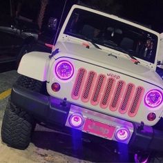 a white jeep with purple lights on it's front bumper and the hood up