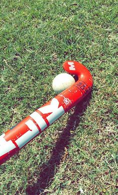 an inflatable baseball bat laying on the ground with a ball attached to it