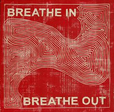 a red and white sign with the words breathe out on it's front side