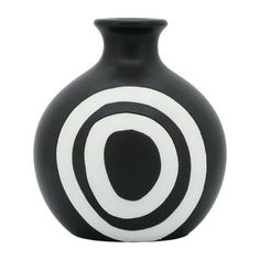 a black and white vase with an oval design on the front, sitting against a white background