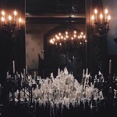 an elaborately decorated room with candles and chandelier