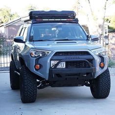 the front end of a silver four door suv with an off road bumper mounted on it