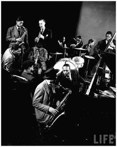 a black and white photo of men playing instruments