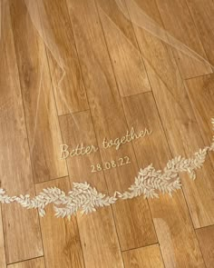 the bride's name is etched on her wedding day veil, which was embroidered onto the floor