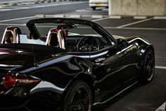 a black sports car parked in a parking lot