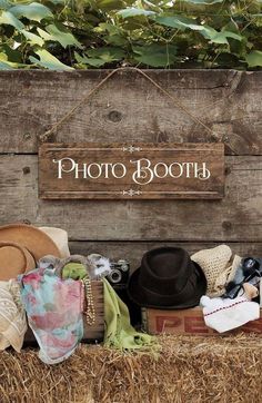 there is a sign that says photo booth with hats and other items on the ground