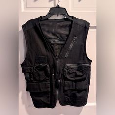 Never Worn, Put To Pit 20.5” Length 23” Black Utility Tops For Fall, Black Cotton Techwear Vest, Black Cotton Vest For Spring, Black Cotton Utility Vest, Black Casual Vest With Pockets, Casual Black Vest With Pockets, Black Utility Tops For Streetwear, Black Utility Streetwear Tops, Urban Style Black Cotton Vest