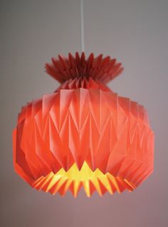 an origami light hanging from the ceiling