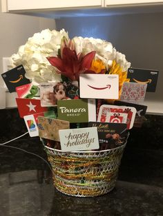 a basket filled with lots of cards and flowers