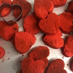 red heart shaped cookies are sitting on a table