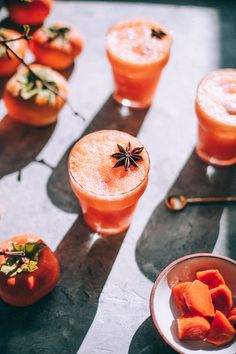 several glasses filled with drinks sitting on top of a table