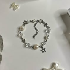 "Pearl Bracelet with Star charms! (adjustable length: with adjuster 5.5\" -> 7.5\") Made with Freshwater pearls, Stainless Steel hardware, and Glass beads Each product is handmade, so slight variations may occur! each is uniquely yours 🤞 🌷͜ (ᵔ ̮ ᵔ)› [ordering 2 or more items from my shop will get you a random freebie]  🍡each order comes with a sticker or candy 🍓CARE INSTRUCTIONS (non ss metals) Keep away from liquids! Creams/Perfumes/Creams, etc. Make sure to remove before showering and slee Bracelet Ideas Metal, Handmade White Beaded Metal Bracelets, Handmade White Beaded Metal Bracelet, Vintage Beaded Bracelets For Gift, Vintage Silver Beaded Bracelets As Gift, Metal Beaded Rosary Bracelet Gift, Metal Beaded Rosary Bracelet For Gift, Bracelet To Make, Small Business Jewelry