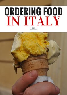 a hand holding an ice cream cone in front of a building with the words ordering food in italy