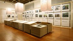 a room filled with lots of pictures and boxes on the floor next to each other