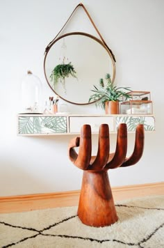 a mirror and some plants on a shelf