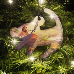 an ornament hanging from a christmas tree with the image of a woman on it