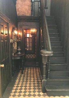 an entry way with black and white checkered flooring, chandelier and table