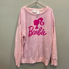 a pink sweater with the word barbie on it