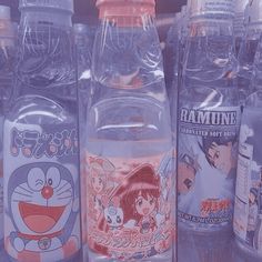 several bottles of water are lined up in a row