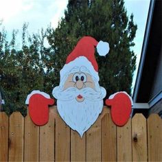 a wooden fence with a santa clause on it