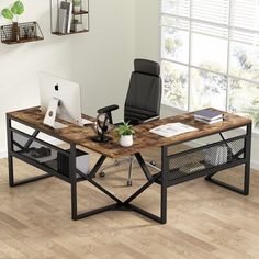 an office desk with a computer on it in front of a window and wooden floor