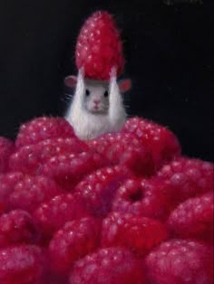 a mouse in a pile of raspberries looking at the camera while wearing a red hat