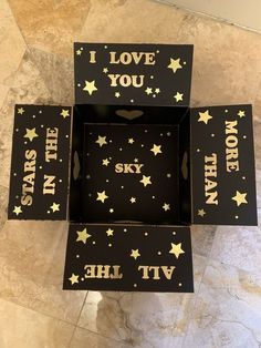 four black boxes with gold stars and i love you written on the inside, one in the middle