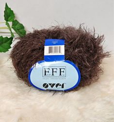 a ball of fake fur sitting on top of a white rug