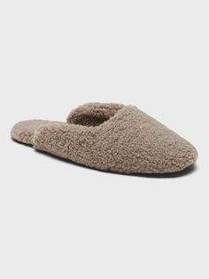 a women's slipper that is made out of sheepskin and has an open toe