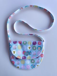 a small blue purse with flowers on it