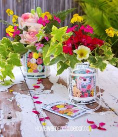 two vases filled with flowers sitting on top of a wooden table next to each other